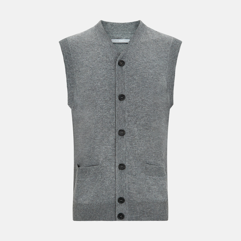 The Turnbull & Asser Ash Grey V-neck Sleeveless Cardigan features a button-up front, two front pockets, and ribbed edges, shown against a plain white background.