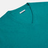 View 2 of product The Turnbull & Asser Turquoise Cashmere V-neck Jumper features long sleeves with ribbed cuffs and hem, displayed on a plain white background—a chic knitwear addition.