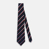 View 2 of product The Turnbull & Asser Red And Blue Stripe Silk Blend Tie, rolled on a white background, features refined diagonal accents—an elegant formal accessory.