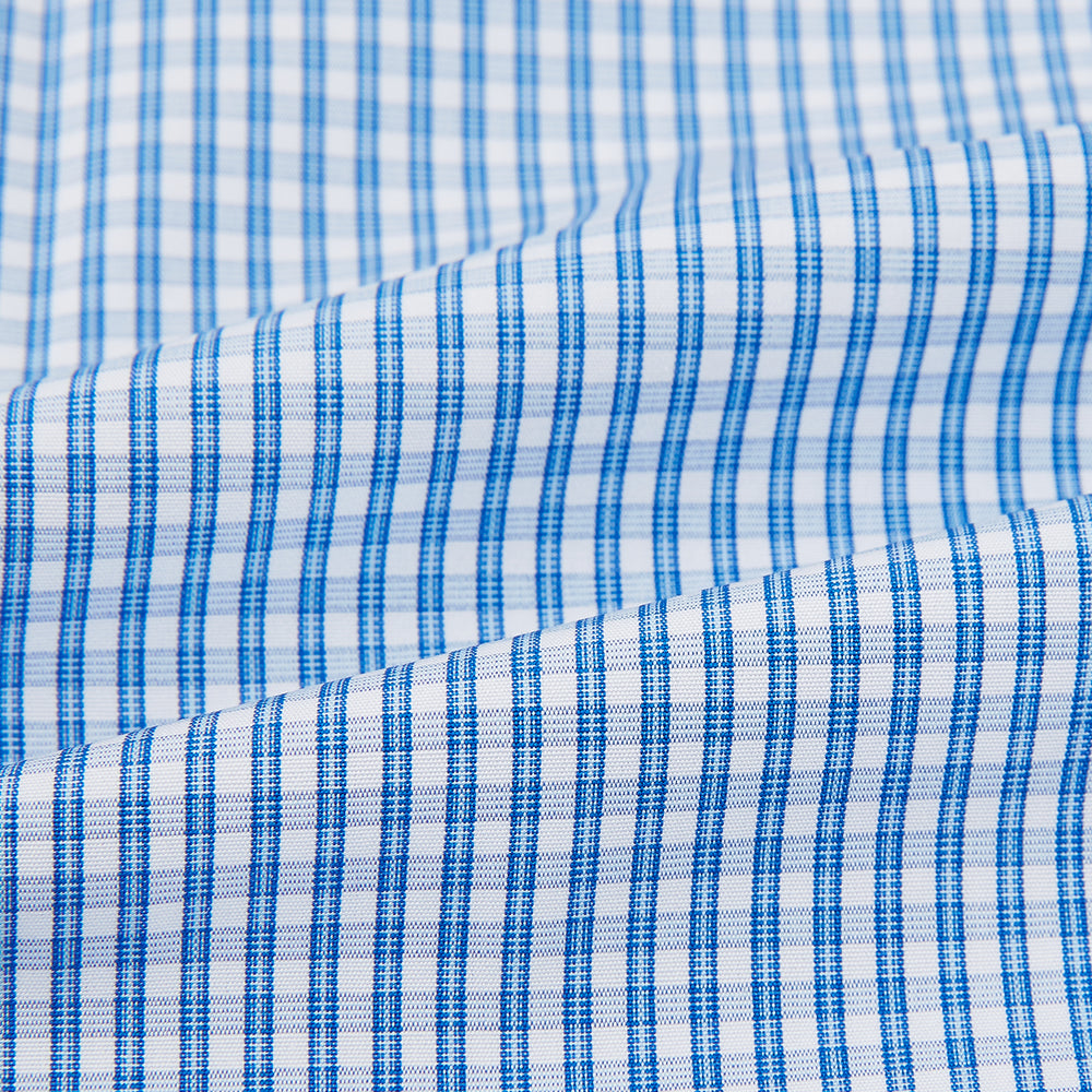 The Turnbull & Asser Blue Multi Micro Check Mayfair Shirt features a classic T&A collar, button-up front, white buttons, cuffed long sleeves, and a refined light blue and white micro check pattern.