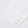 View 2 of product The Turnbull & Asser White Self-On-Self Herringbone Sea Island Quality Cotton Shirt features a T&A collar, 3-button cuffs, and luxurious Egyptian cotton, displayed neatly folded against a light gray background.