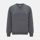 The Turnbull & Asser Storm Grey Cashmere V-neck Jumper features long sleeves, ribbed cuffs and hem—versatile knitwear shown on a white backdrop.