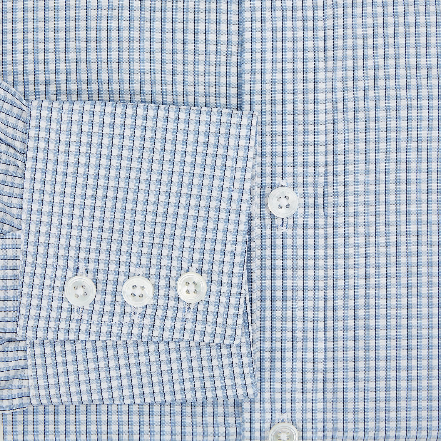 View 4 of product The Turnbull & Asser Blue Micro Shadow Check Mayfair Shirt features a long-sleeve, button-up design with a small blue and white check pattern, pointed T&A collar, and classic cuffs.