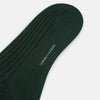 View 3 of product Turnbull & Asser's Olive Mid-Length Socks, crafted from mercerised Egyptian cotton in dark green with ribbed detailing, are displayed against a plain white background, showcasing refined comfort and enduring style.