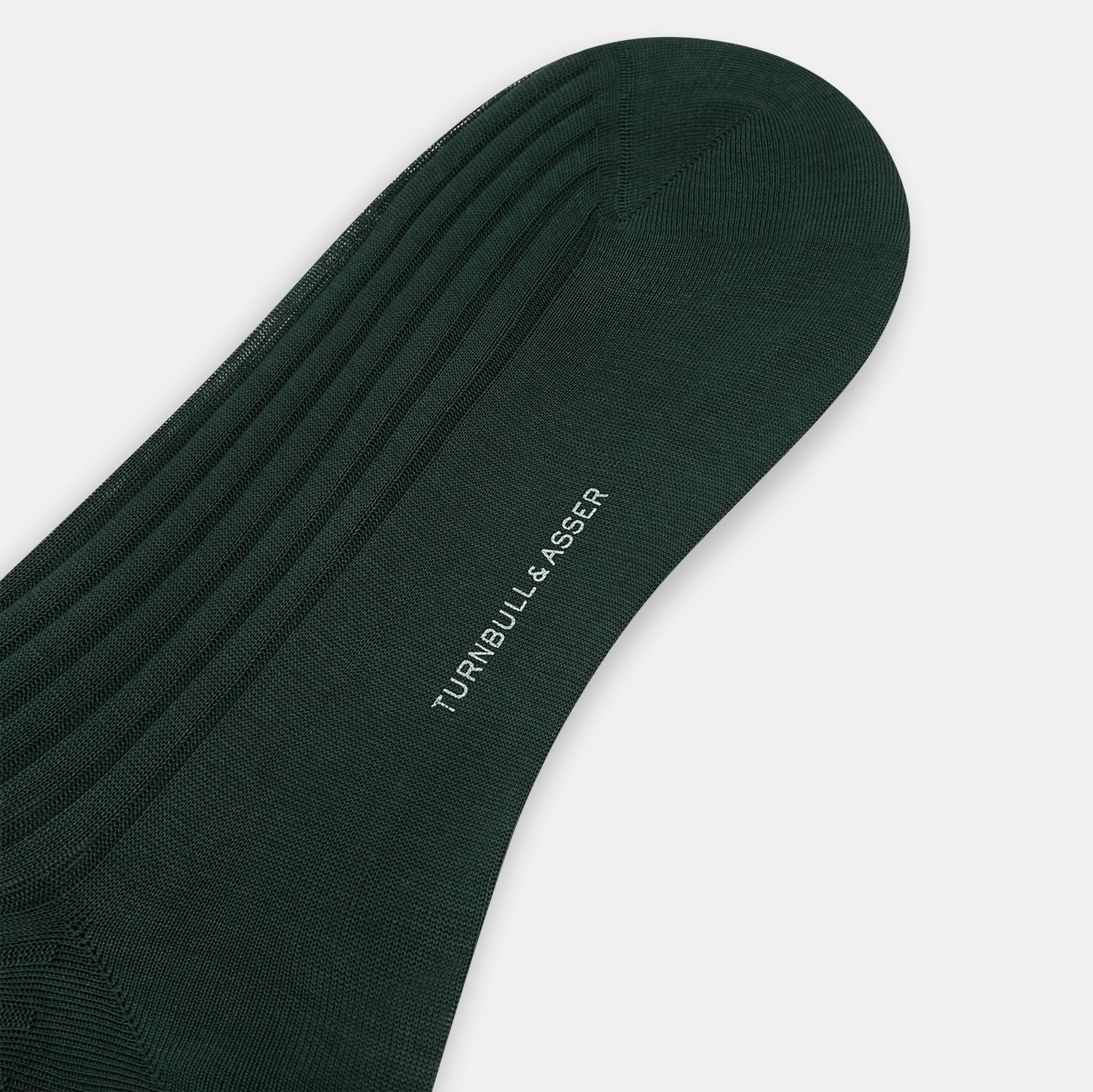 View 3 of product Turnbull & Asser's Olive Mid-Length Socks, crafted from mercerised Egyptian cotton in dark green with ribbed detailing, are displayed against a plain white background, showcasing refined comfort and enduring style.