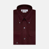 View 1 of product The Turnbull & Asser Burgundy Cashmerello Button Down Shirt features long sleeves, buttoned chest pockets, a spread collar, and is crafted from a soft cotton-cashmere blend, neatly displayed on a plain white background.