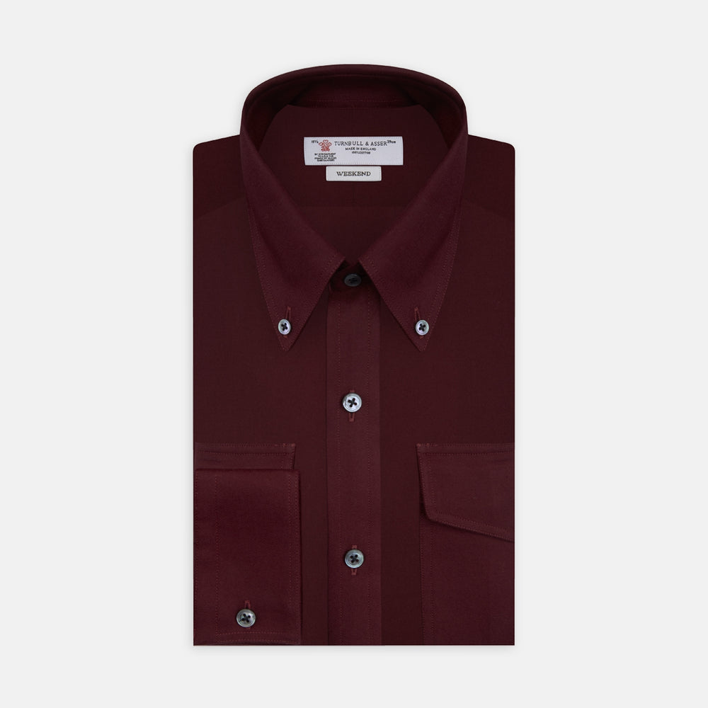 The Turnbull & Asser Burgundy Cashmerello Button Down Shirt features long sleeves, buttoned chest pockets, a spread collar, and is crafted from a soft cotton-cashmere blend, neatly displayed on a plain white background.