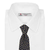View 2 of product The Turnbull & Asser Navy and Gold Paint Spot Silk Tie features evenly spaced gold spots on classic navy silk, rolled and displayed on a plain white background—ideal for complementing your favorite office shirt.