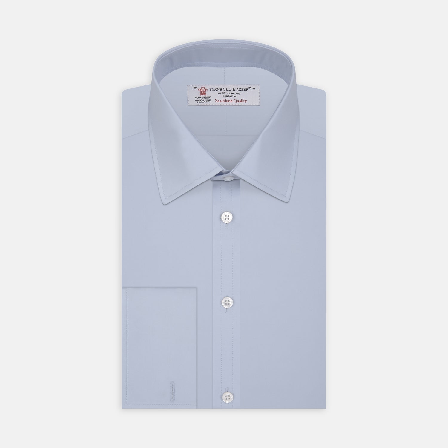 View 1 of product The Turnbull & Asser Light Blue Sea Island Quality Cotton Shirt features a T&A collar, double cuffs, white buttons, and a quality label inside the collar. Displayed on a plain white background.