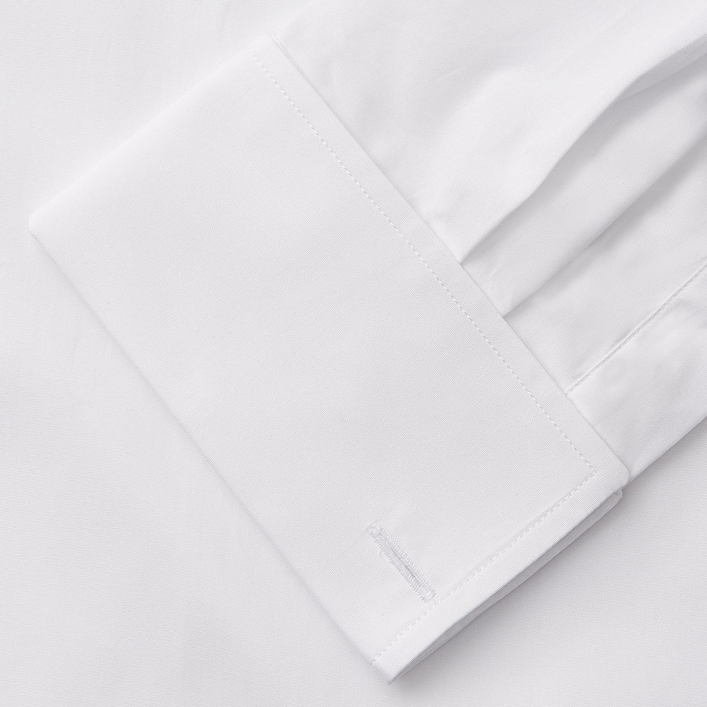 A woman with straight brown hair pulled back wears the Turnbull & Asser White Cotton Marlene Shirt, featuring classic menswear details, paired with high-waisted cream trousers against a neutral background.