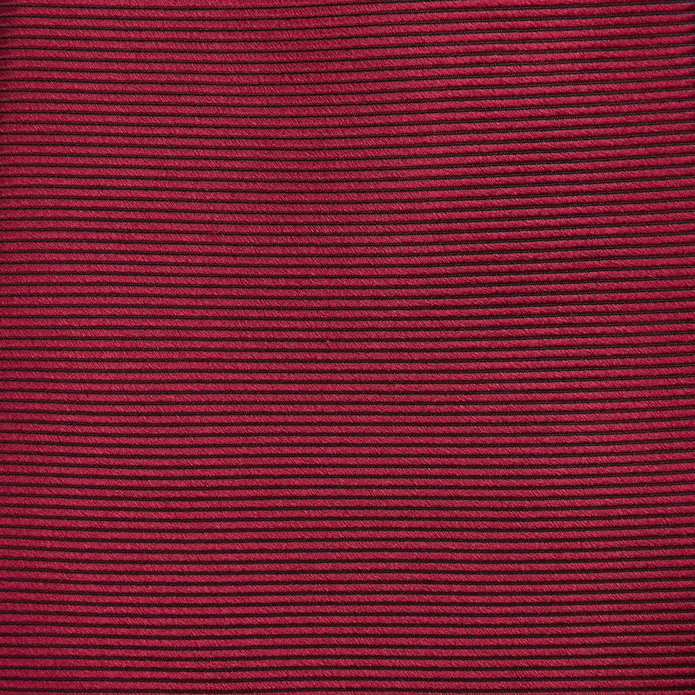A close-up of the Turnbull & Asser HORIZONTAL TWILL BURGUNDY TIE, a textured men's accessory, rolled up and displayed on a plain white background.