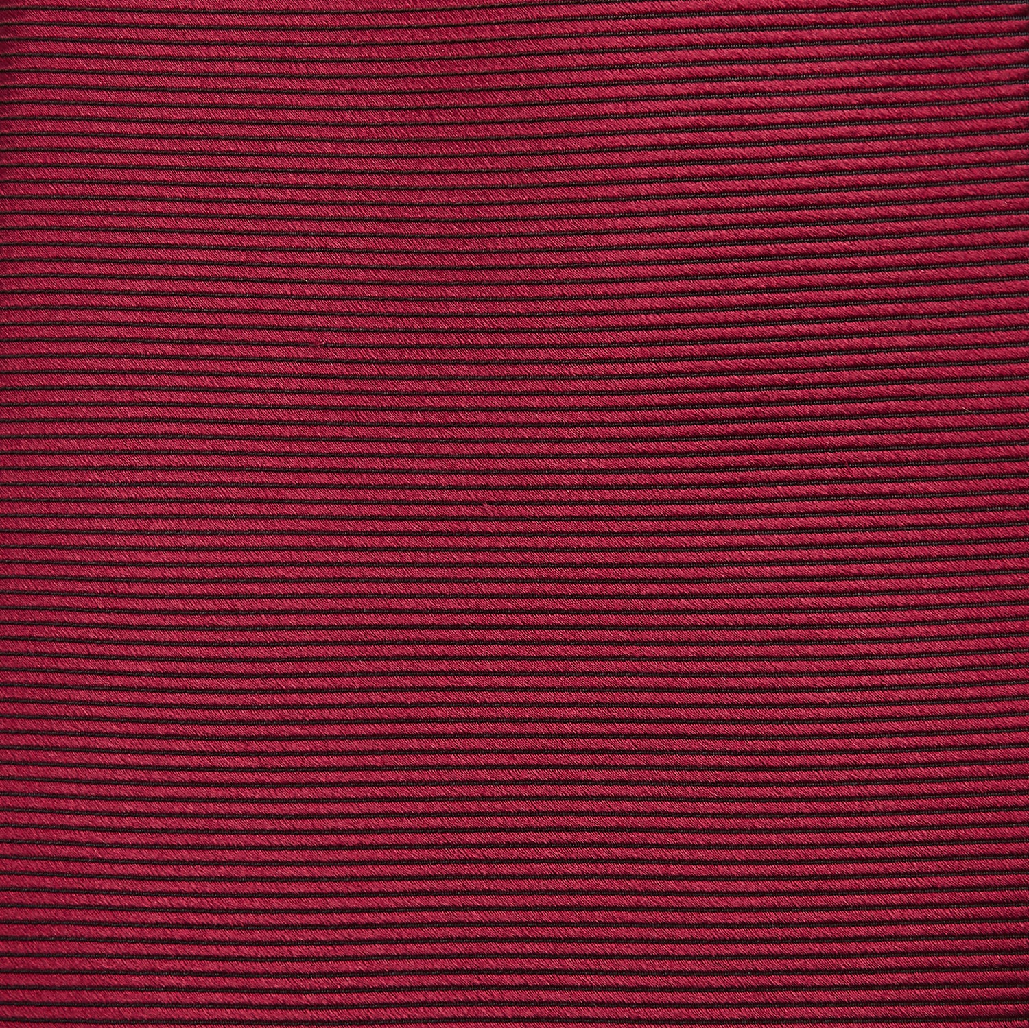 View 3 of product A close-up of the Turnbull & Asser HORIZONTAL TWILL BURGUNDY TIE, a textured men's accessory, rolled up and displayed on a plain white background.