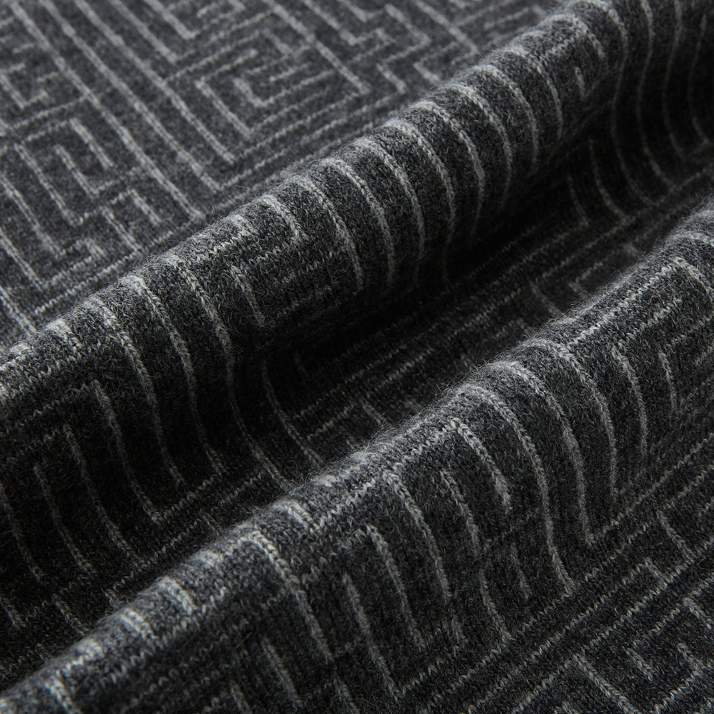 The Turnbull & Asser Grey Fretwork Cashmere Knitted Scarf showcases a geometric maze-like pattern in gray, elegantly looped with draped ends—an essential accessory set against a plain white background.
