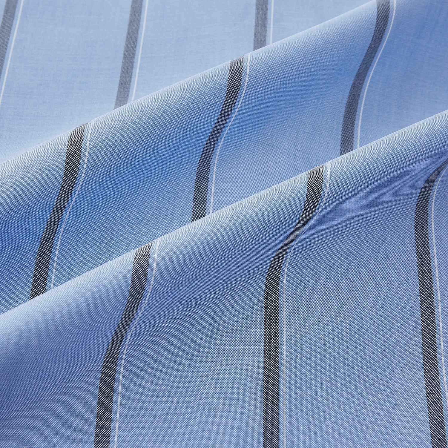 View 8 of product The Sky Blue Track Stripe Westminster Shirt by Turnbull & Asser features long sleeves, a Turnbull collar, and vertical dark blue and white stripes, displayed flat on a white surface.