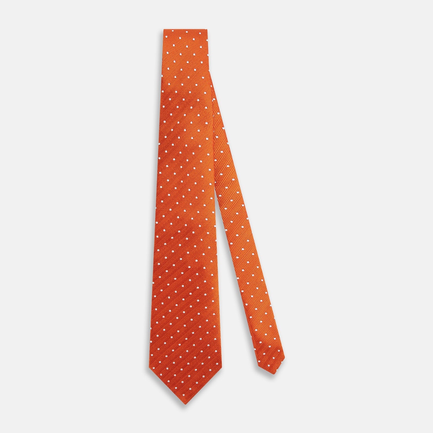 View 2 of product The Turnbull & Asser Orange and White Micro Dot Silk Tie features a subtle herringbone weave with small white dots—an elegant, modern accessory for the office.