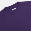 View 9 of product The Turnbull & Asser Purple Cashmere Round Neck Jumper features long sleeves, ribbed cuffs, hem, and collar for an elegant silhouette. This versatile knitwear piece is shown against a white background.