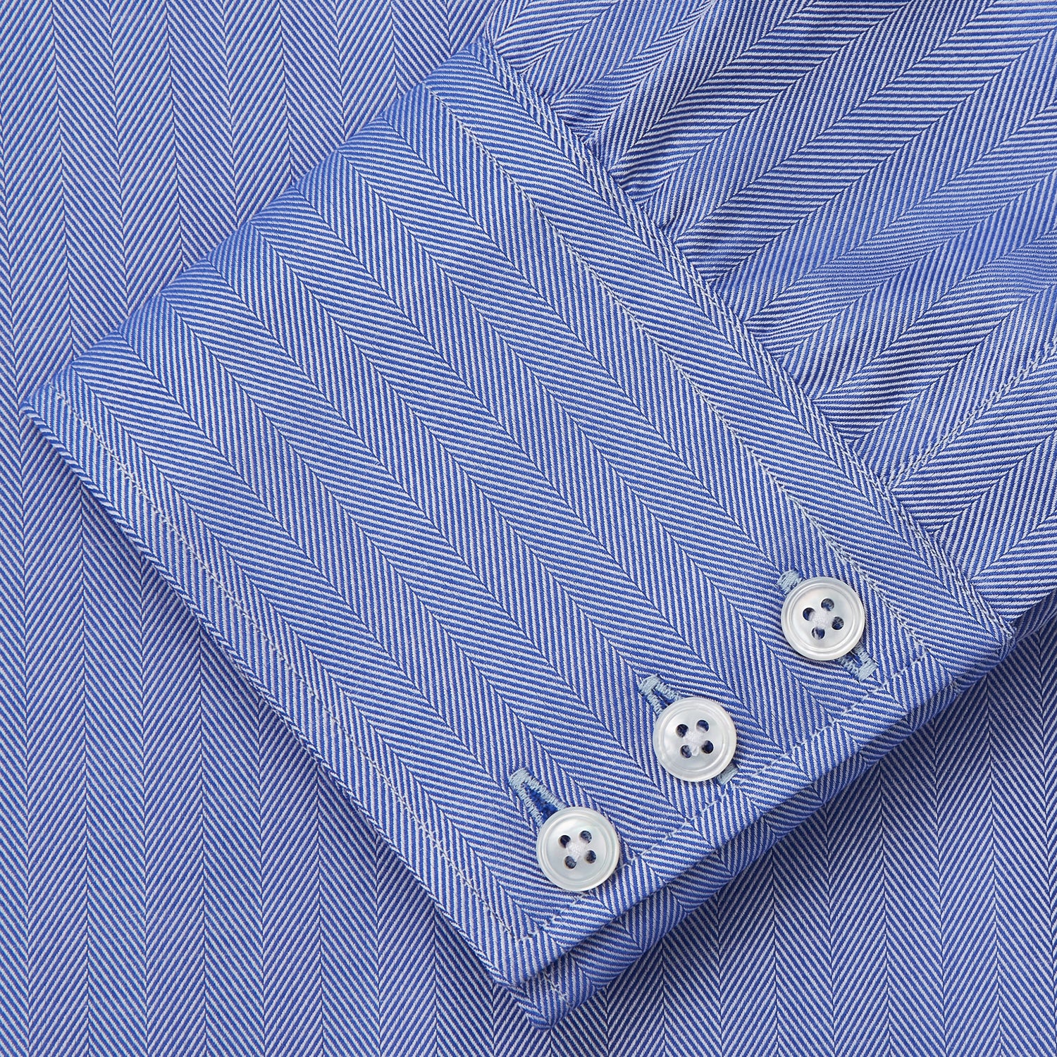 View 3 of product Turnbull & Asser's Blue Herringbone Tailored Fit Shirt with a Kent collar and white buttons is shown laid flat on a white background.