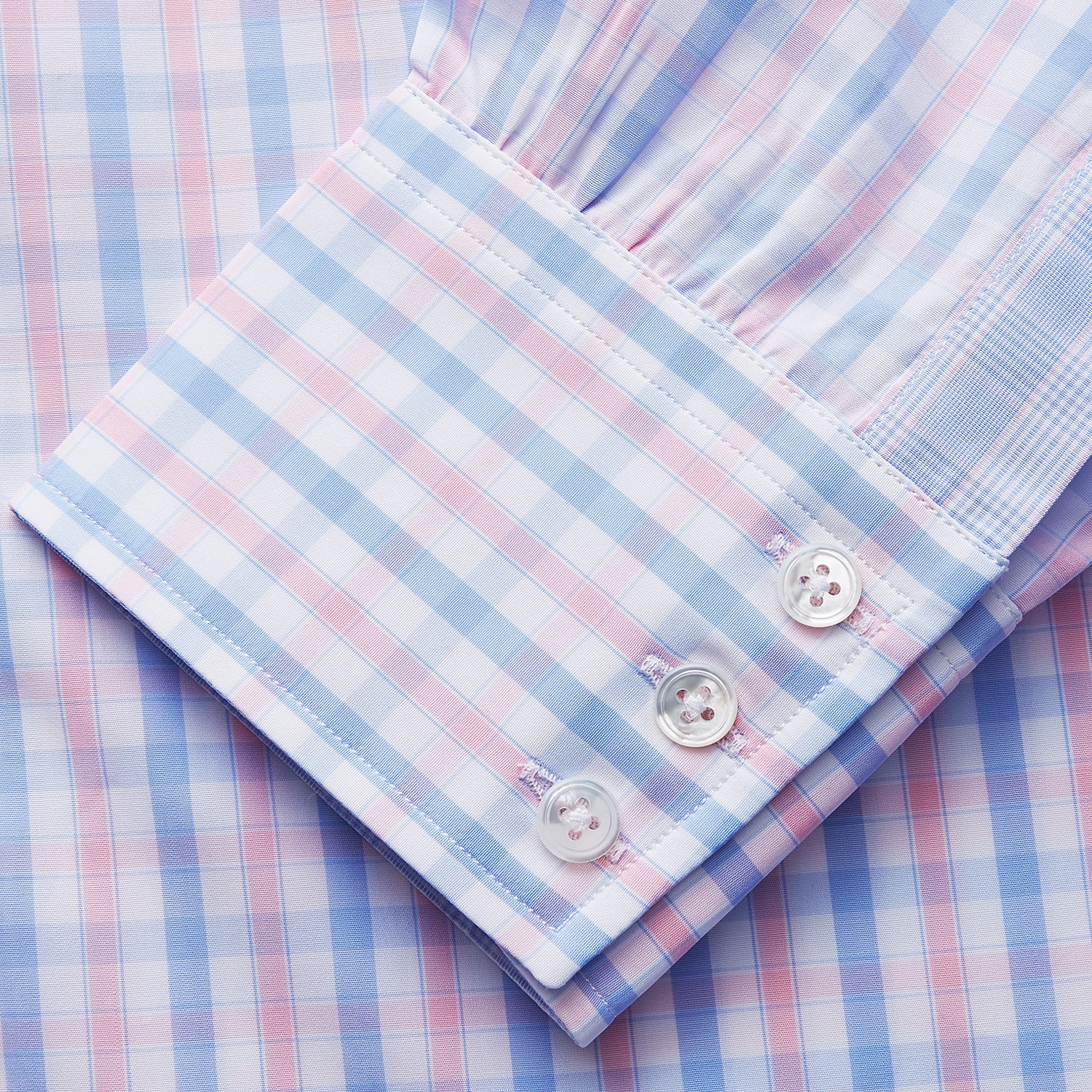View 3 of product The Turnbull & Asser Red and Blue Multi Check Cotton RE-PURPOSE Mayfair shirt is a sustainable, long-sleeve button-up with a collar and cuffed sleeves, crafted from recycled fabrics and shown laid flat on a white background.