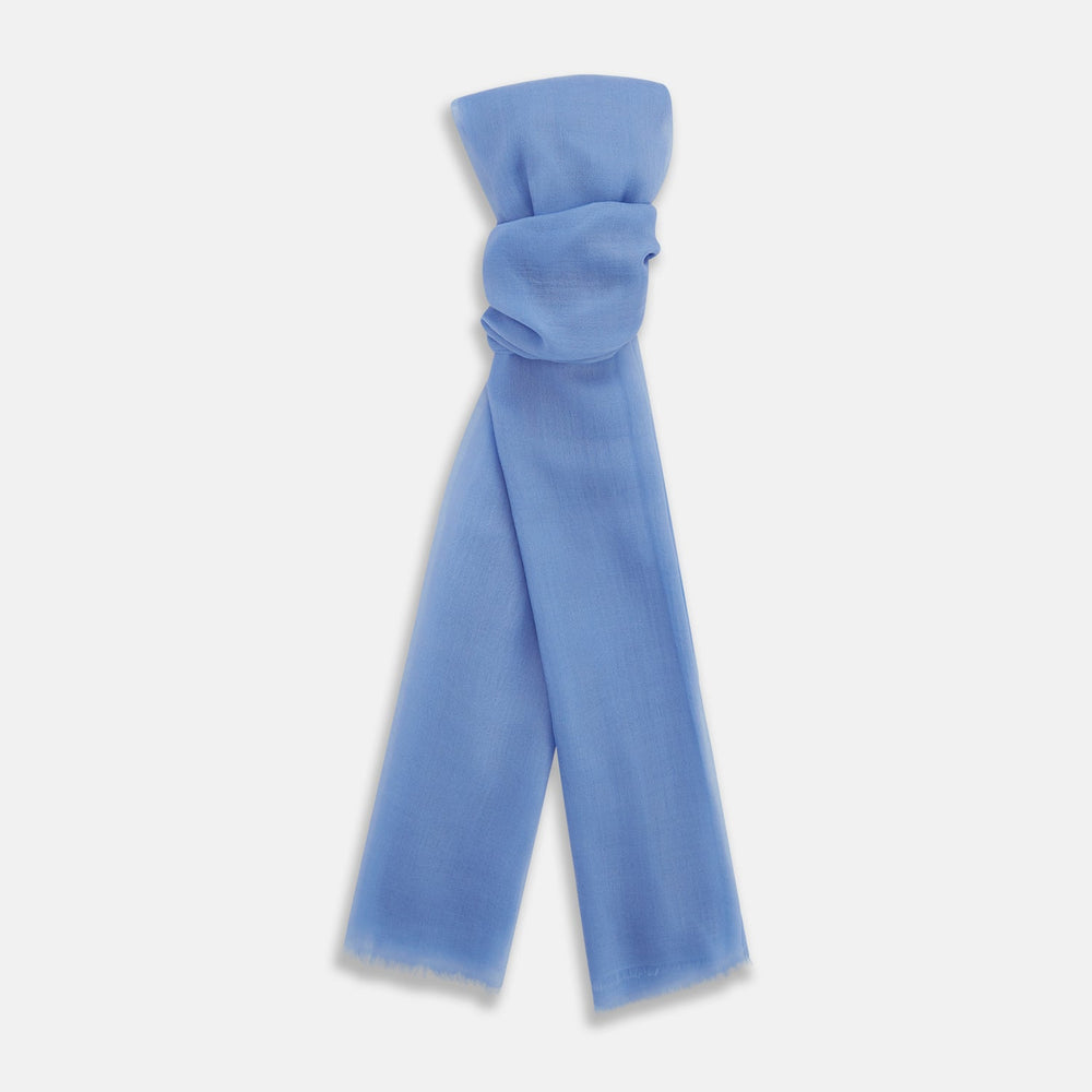 The Azzurro Cashmere Scarf by Turnbull & Asser is shown in light blue, hand-dyed cashmere, semi-sheer and loosely knotted, displayed against a plain white background.
