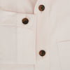 View 4 of product The Turnbull & Asser Pale Pink Hyde Overshirt is a long-sleeve, sanforised cotton button-up with a left chest pocket and dark buttons, shown laid flat on a white background.