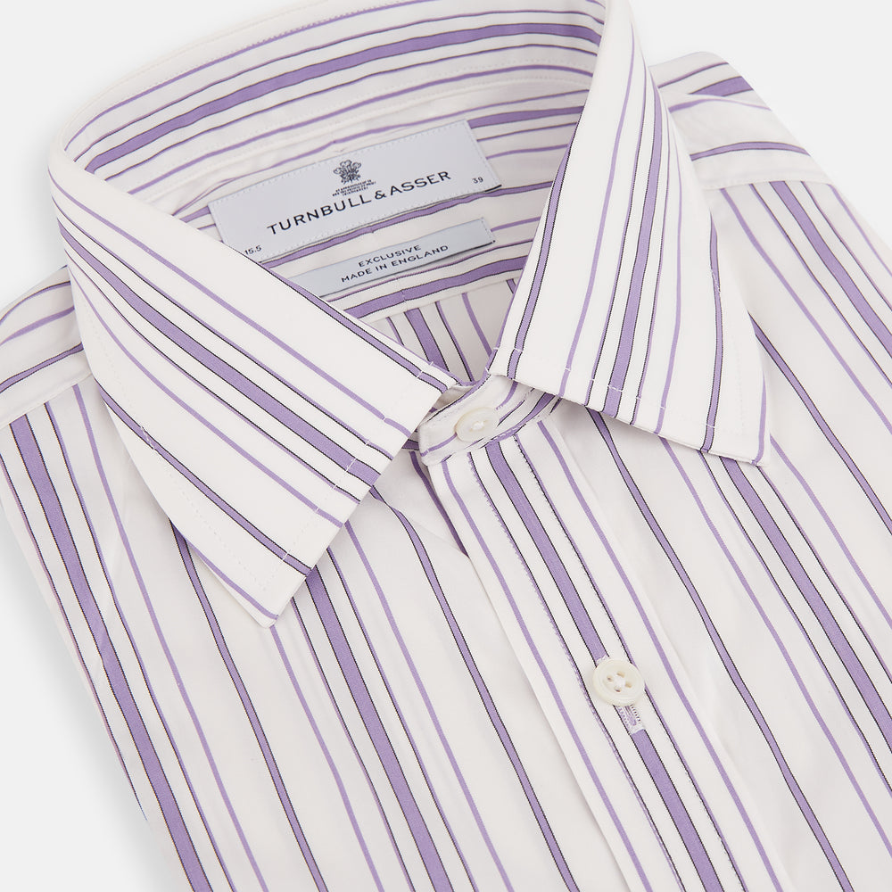 The Purple Multi Stripe Mayfair Shirt by Turnbull & Asser is a long-sleeve, collared button-up featuring vertical blue and purple stripes on white, ideal for formal occasions. The shirt is neatly displayed flat against a white background.