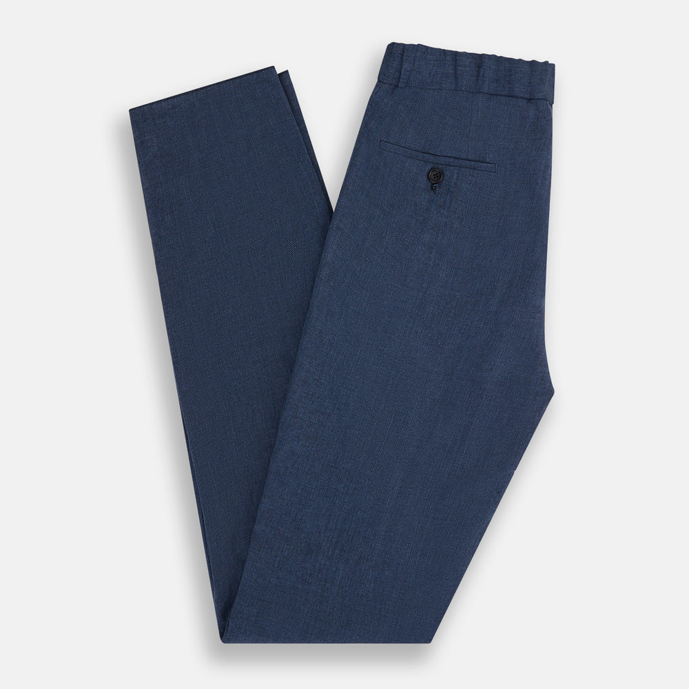 Turnbull & Asser Denim Blue Linen Herringbone Miles Trousers with a straight-leg fit, elasticated waist, and drawstring tie, shown against a plain white background.