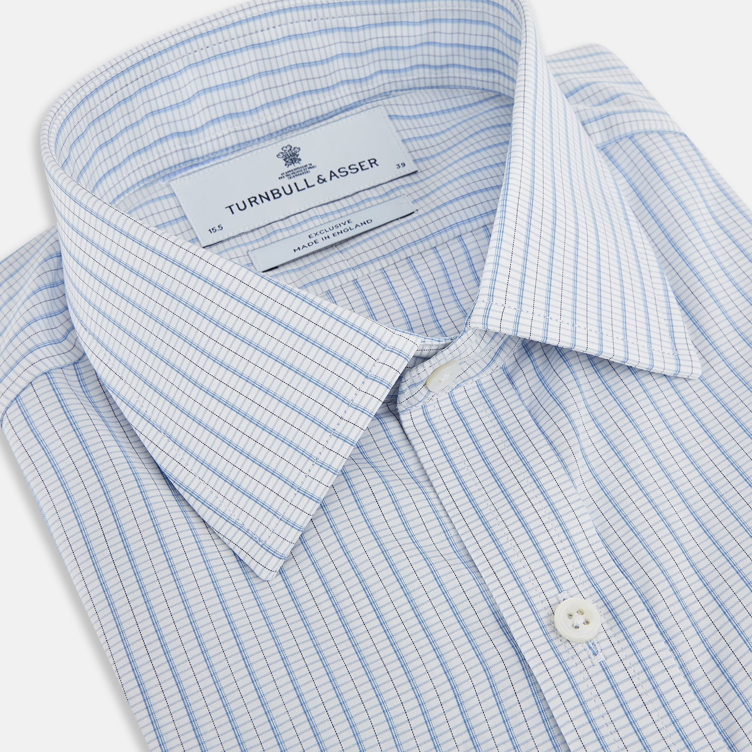 View 2 of product The Turnbull & Asser Blue Graph Check Mayfair Shirt features a classic T&A collar, Mayfair fit, buttoned cuffs, and long sleeves with light blue graph checks on a white background.