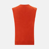 View 3 of product The Turnbull & Asser Red Orange Cashmere Sleeveless Vest with a V-neck, ribbed hem, and minimalist design is showcased against a white background—ideal for the refined gentleman.