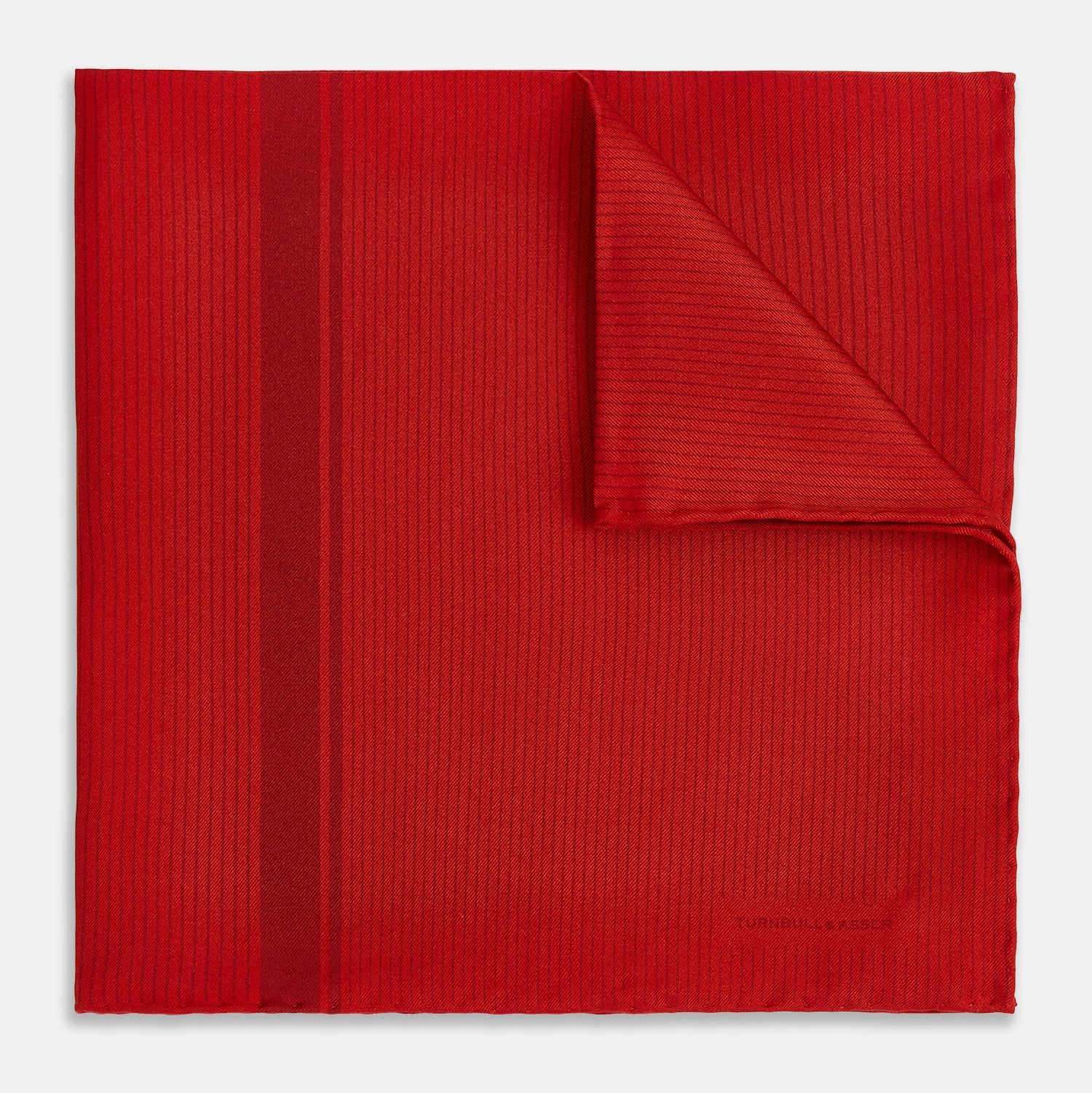View 1 of product The Red and Burgundy Stripe Silk Pocket Square by Turnbull & Asser features subtle vertical stripes and a darker red stripe along one side, with “Turnbull & Asser” embossed in the fabric and a textured, turned-down corner.
