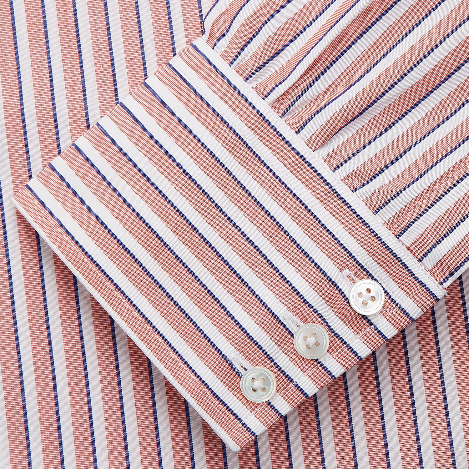 View 3 of product The Turnbull & Asser Orange and White Stripe Cotton Regular Fit Mayfair Shirt features vertical stripes, a classic collar, and buttoned cuffs—an essential men’s wardrobe piece, shown laid flat on a white background.