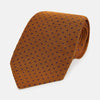 View 1 of product The Turnbull & Asser Purple and Orange Micro Dot Silk Tie, featuring a vibrant polka dot pattern, makes a bold men's accessory and is shown rolled up on a white background.