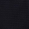 View 3 of product The GRENADINE NEW NAVY TIE by Turnbull & Asser features a dark navy blue woven texture, making it the perfect accessory for refined looks. Displayed against a plain white background.