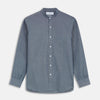View 1 of product The Turnbull & Asser Plain Blue Oxford Cotton Weekend Fit Blake Shirt features long sleeves, a stand collar, and white buttons, displayed flat on a white background.