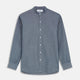 The Turnbull & Asser Plain Blue Oxford Cotton Weekend Fit Blake Shirt features long sleeves, a stand collar, and white buttons, displayed flat on a white background.
