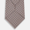 View 3 of product The Turnbull & Asser Navy and Lilac Micro Dot Silk Tie, featuring subtle micro dots, is the perfect refined accessory for smart outfits, shown rolled up against a plain white background.