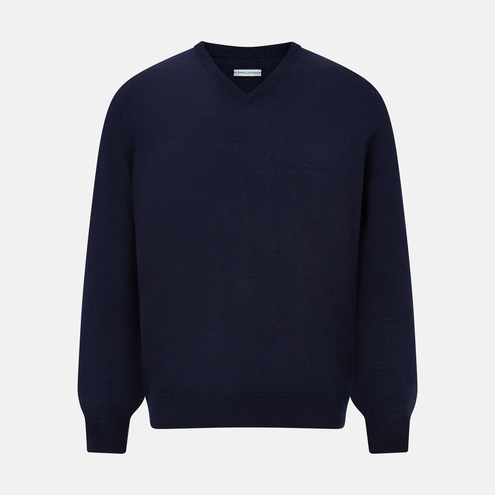 The Turnbull & Asser Navy Fine Merino V-Neck Jumper is displayed against a white background, featuring ribbed cuffs and hem for timeless style in a classic, plain long-sleeve design.