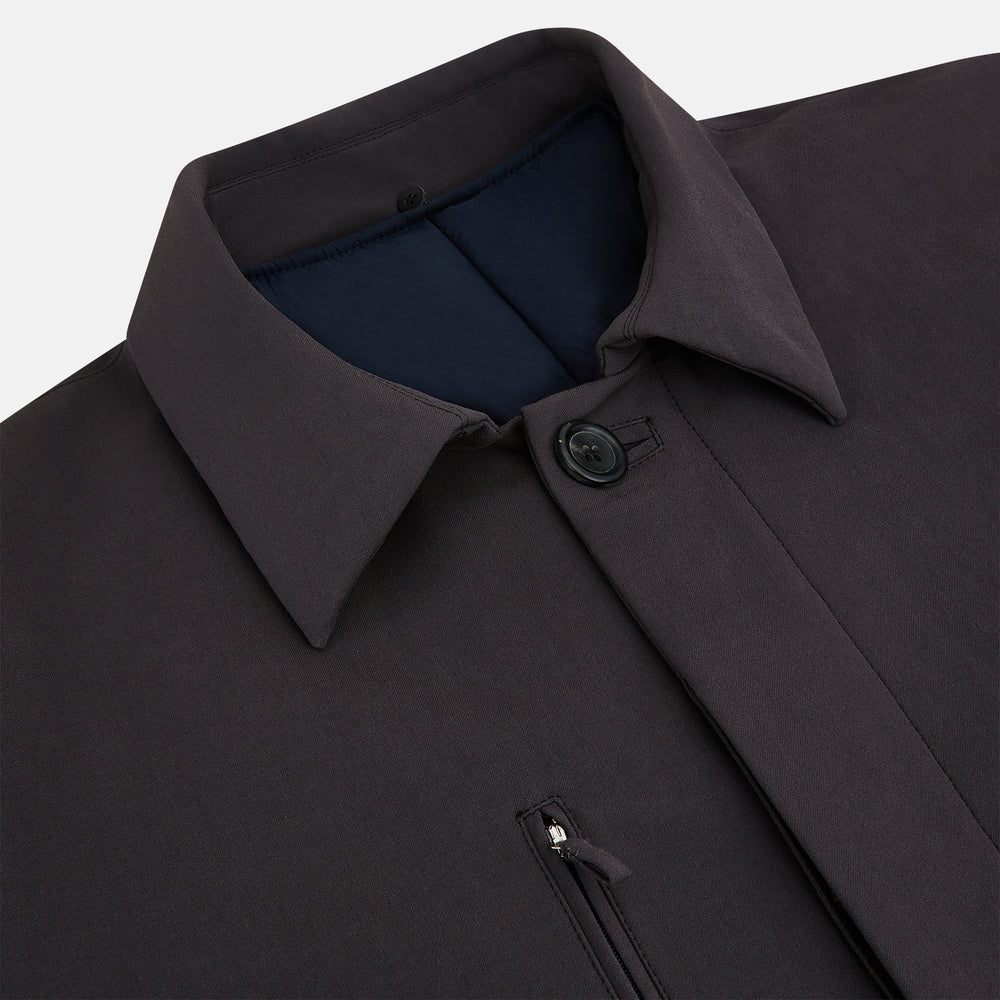 The Dark Chocolate John Arthur Trench Coat by Turnbull & Asser features a pointed collar, two large slanted side pockets, and a vertical chest pocket—a versatile 2-in-1 piece ideal for any occasion.