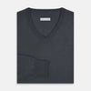 View 4 of product The Turnbull & Asser Charcoal Grey Merino V-Neck Jumper is shown against a white background, featuring long sleeves, a relaxed fit, and ribbed cuffs and hem for comfort.