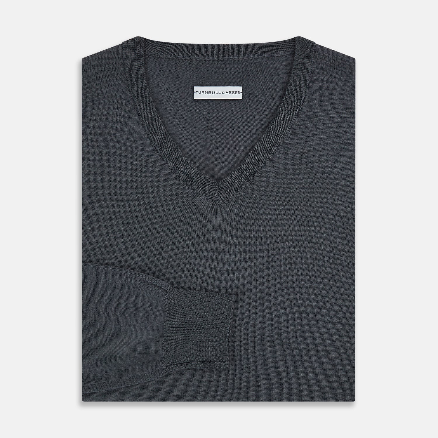 View 4 of product The Turnbull & Asser Charcoal Grey Merino V-Neck Jumper is shown against a white background, featuring long sleeves, a relaxed fit, and ribbed cuffs and hem for comfort.