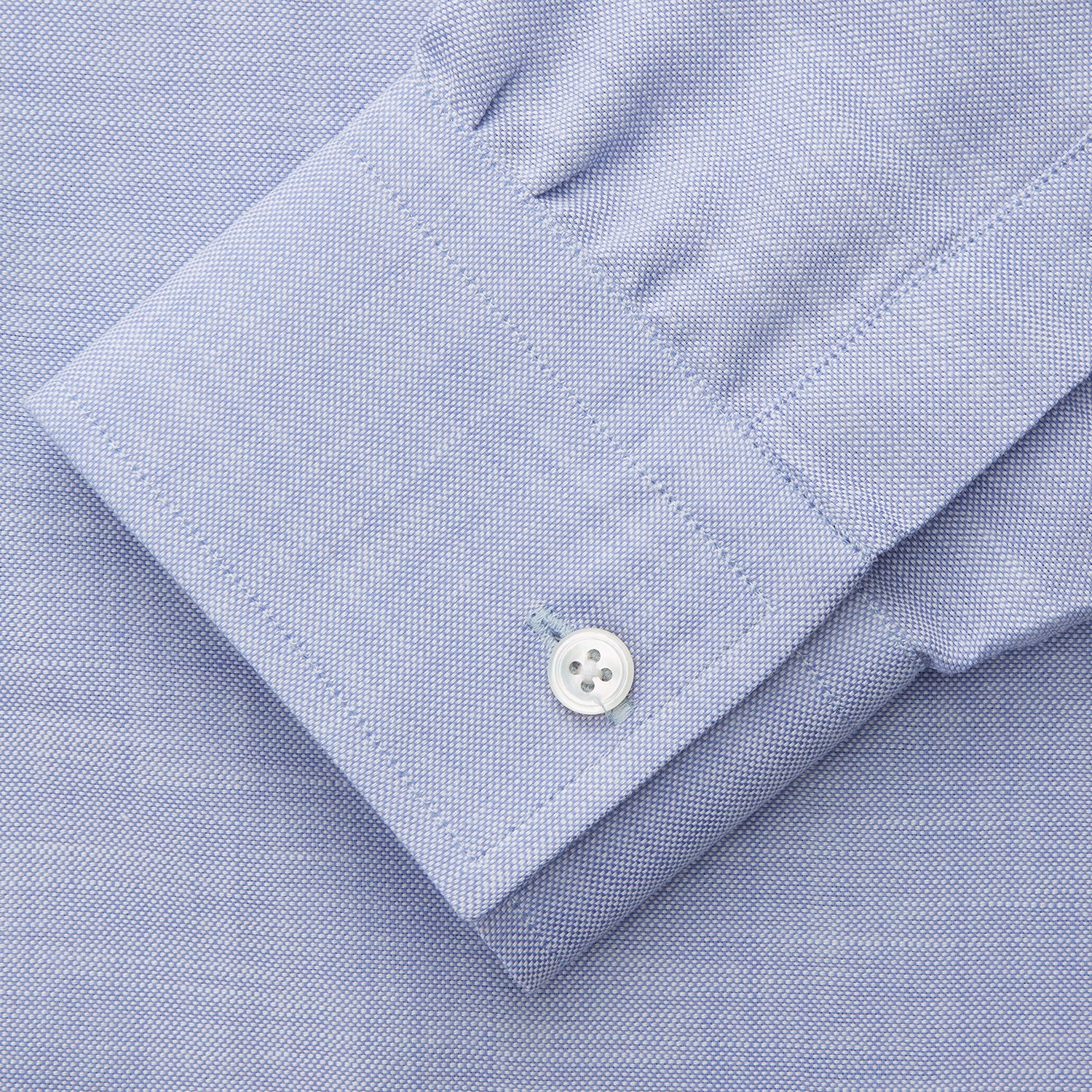 View 4 of product The Turnbull & Asser Pale Blue Weekend Fit Hayne Shirt features a Dorset collar, white buttons, and 1-button cuffs. This casual, long-sleeve button-down is displayed laid flat on a white background.