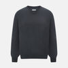 View 1 of product The Turnbull & Asser Charcoal Grey Merino V-Neck Jumper is shown against a white background, featuring long sleeves, a relaxed fit, and ribbed cuffs and hem for comfort.