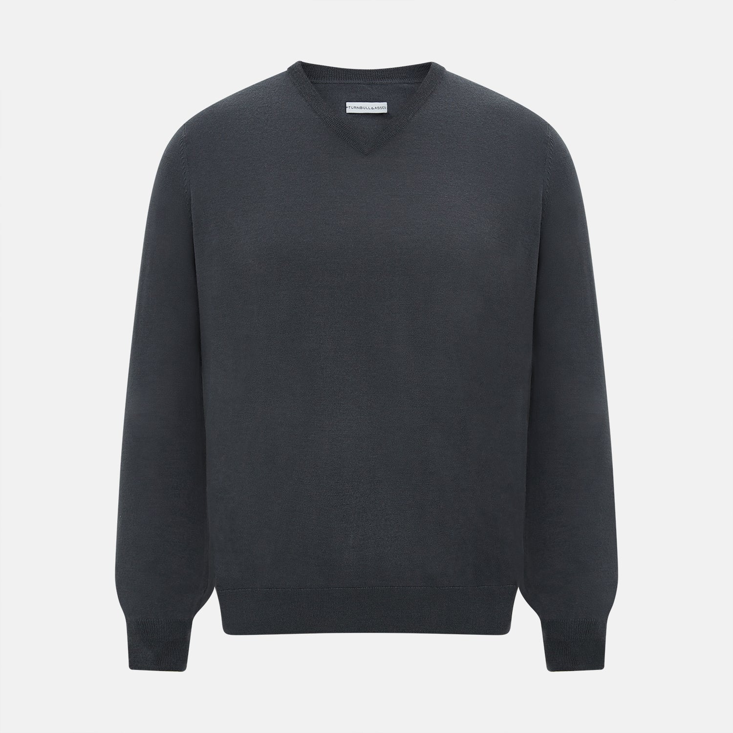 View 1 of product The Turnbull & Asser Charcoal Grey Merino V-Neck Jumper is shown against a white background, featuring long sleeves, a relaxed fit, and ribbed cuffs and hem for comfort.