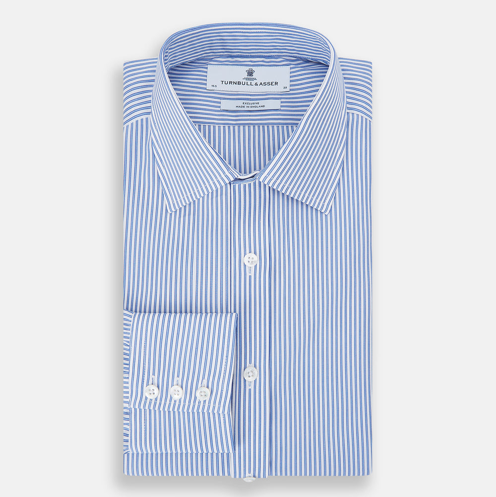 The Sky Blue Halo Stripe Mayfair Shirt by Turnbull & Asser, a long-sleeved button-up with thin blue and white vertical stripes, classic collar and cuffs, is shown laid flat on a white background.