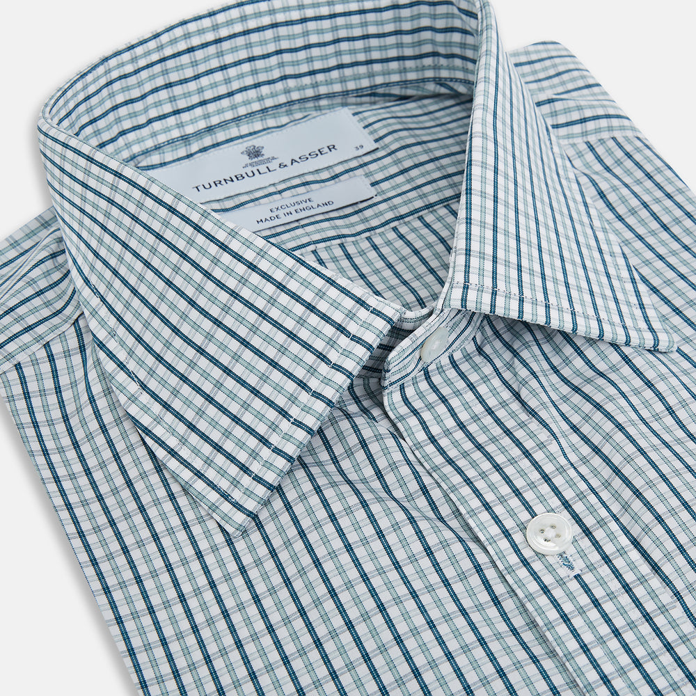 The Turnbull & Asser Light Petrol Micro Tattersall Check Mayfair Shirt features long sleeves, a classic collar, buttoned cuffs, and is crafted from Italian cotton in a refined blue and white check pattern.