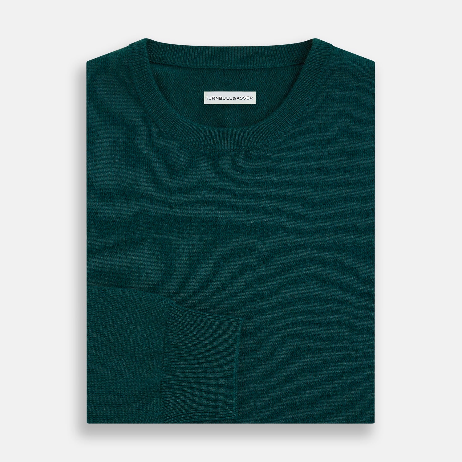 View 4 of product The Turnbull & Asser Moss Green Cashmere Round Neck Jumper, shown on a plain white background, is men's knitwear with long sleeves and a classic design featuring ribbed cuffs, neckline, and hem for timeless style.