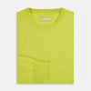 View 7 of product The Turnbull & Asser Lemon Green Cashmere Round Neck Jumper features long sleeves with ribbed cuffs and hem, displayed on a white background.