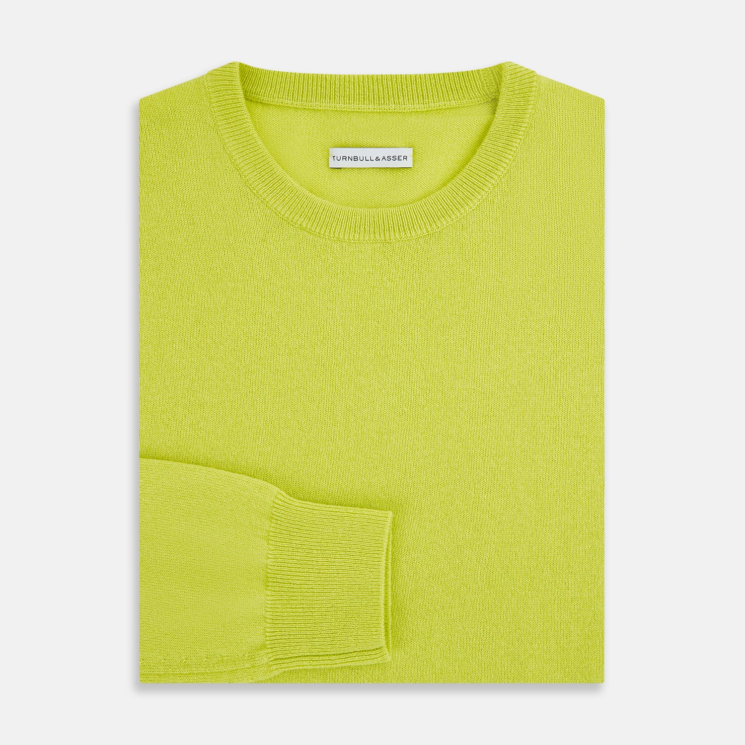 View 7 of product The Turnbull & Asser Lemon Green Cashmere Round Neck Jumper features long sleeves with ribbed cuffs and hem, displayed on a white background.