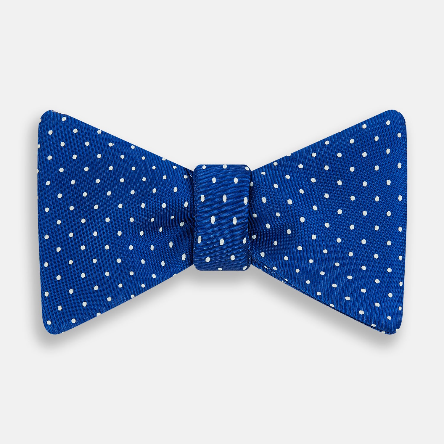 View 1 of product The Turnbull & Asser Electric Blue and White Spot Silk Bow Tie features evenly spaced white polka dots on vibrant silk, shown against a plain white background.
