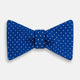 The Turnbull & Asser Electric Blue and White Spot Silk Bow Tie features evenly spaced white polka dots on vibrant silk, shown against a plain white background.