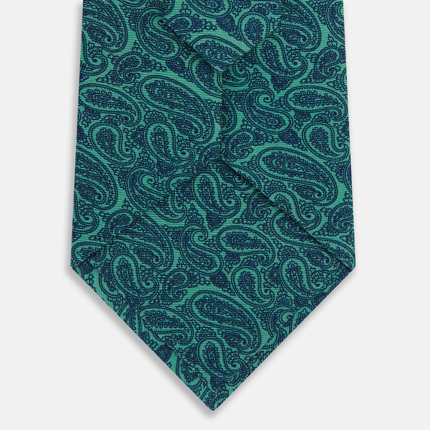 View 3 of product The Turnbull & Asser Kelly Green Paisley Silk Tie is shown rolled on a plain white background, featuring an intricate paisley pattern in rich green tones.